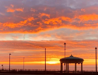 localsunrise Sky glowing orange from a bright sunrise.